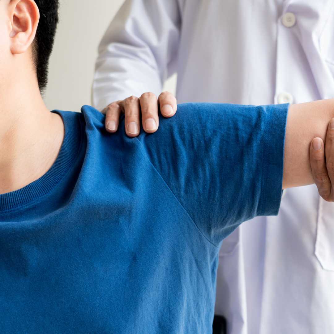 A patient getting their shoulder checked.